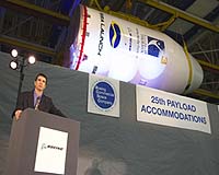 Jim Cappa, leader of the Payload Accommodations Hardware integrated product team for Boeing Commercial Space Company, congratulates employees and customers at the Dec. 14 unveiling of the 25th Payload Accommodations package for Sea Launch Company, LLC. The payload accommodations fairing is a protective shell, four stories high, that protects a satellite throughout the launch phase of a mission. Photo Credit: Boeing Image