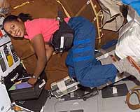 STS-116 Mission Specialist Joan Higginbotham retrieves items from a drawer on the middeck of the Space Shuttle Discovery during flight day six activities. Image Credit: NASA TV